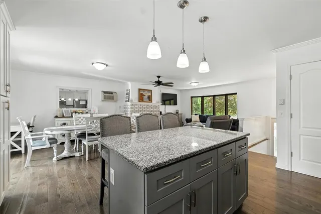 a kitchen with a stove a sink a dining table and chairs