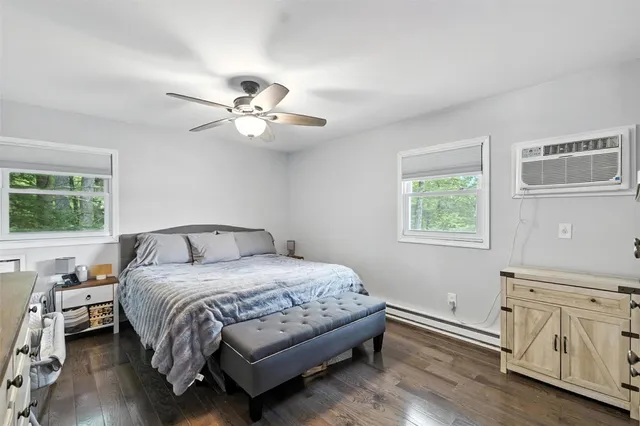 a bathroom with a sink a toilet a mirror and shower curtain