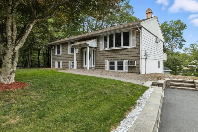 a front view of house with yard and green space