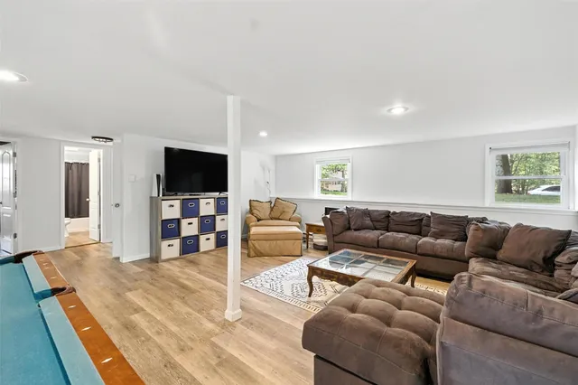 a living room with furniture pool and a flat screen tv