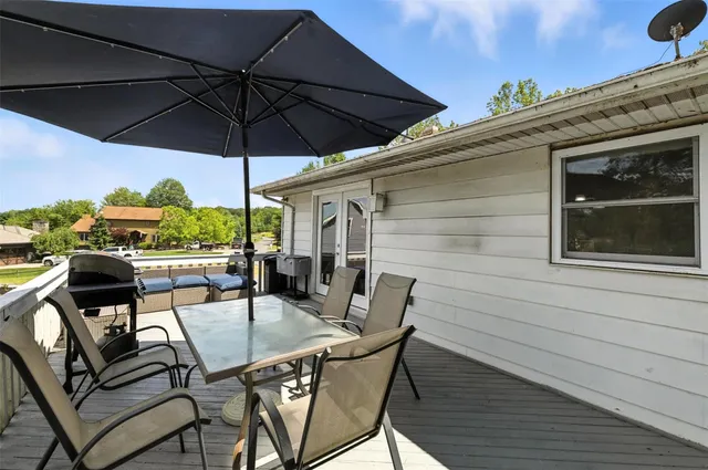 a view of balcony with outdoor seating and wooden floor