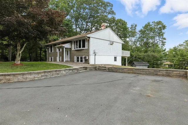 a view of a patio with table and chairs under an umbrella