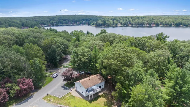 an aerial view of residential house with outdoor space and lake view