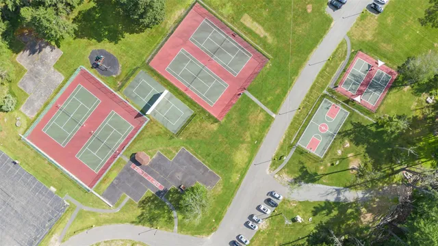 an aerial view of residential houses with outdoor space and street view