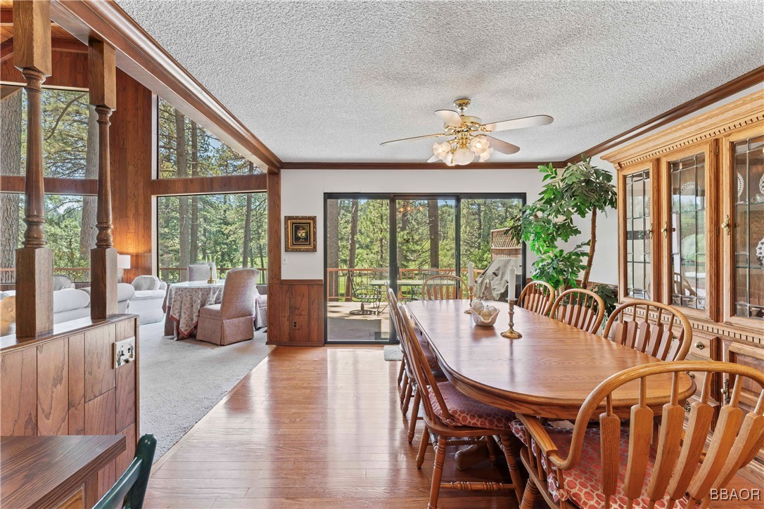524 Golf Course Road Lake Arrowhead, CA 92352 - Photo 11 of 50 a view of a dining room with furniture large windows and wooden floor