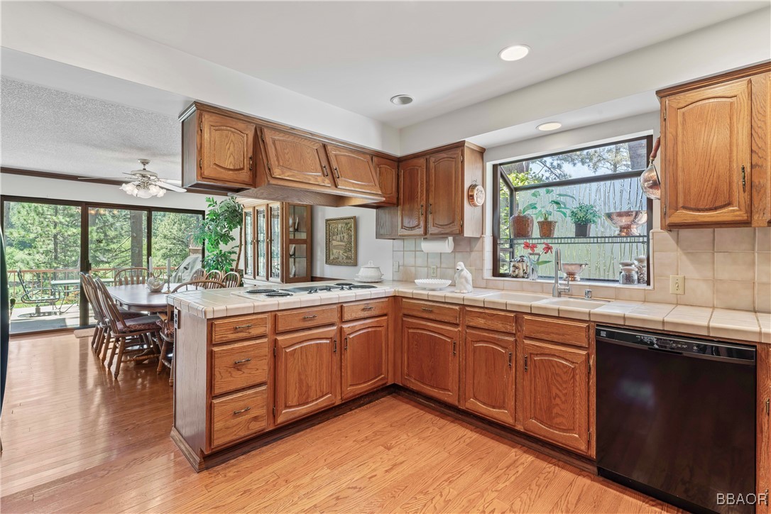 524 Golf Course Road Lake Arrowhead, CA 92352 - Photo 16 of 50 a kitchen with stainless steel appliances granite countertop sink stove and wooden cabinets