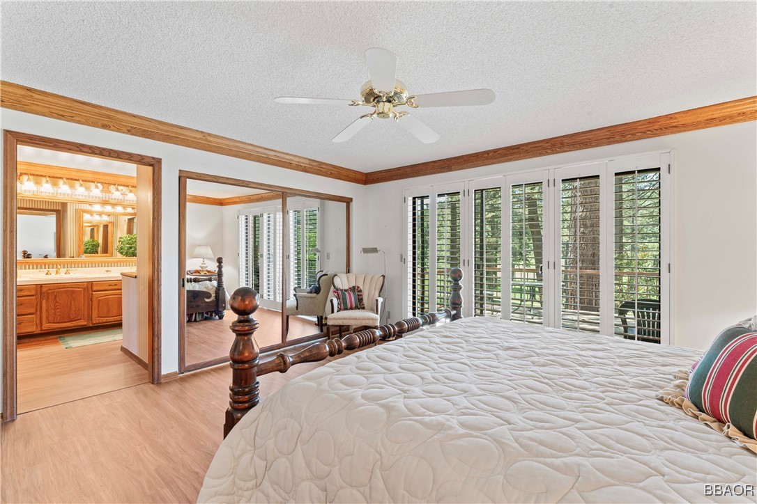 524 Golf Course Road Lake Arrowhead, CA 92352 - Photo 24 of 50 a bedroom with a large bed and a large window