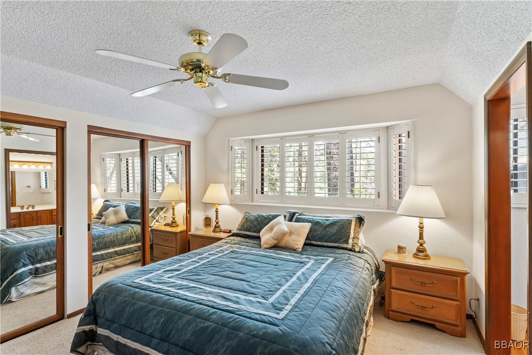 524 Golf Course Road Lake Arrowhead, CA 92352 - Photo 35 of 50 a bedroom with a bed and wooden floor