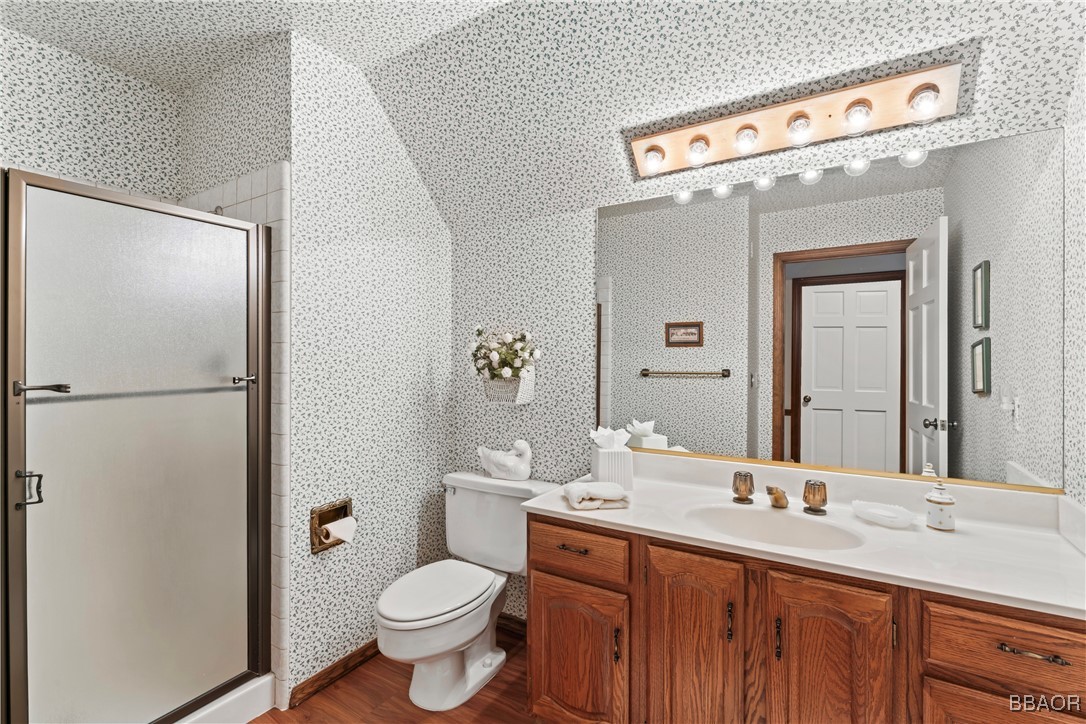 524 Golf Course Road Lake Arrowhead, CA 92352 - Photo 38 of 50 a bathroom with a sink a toilet a mirror and shower