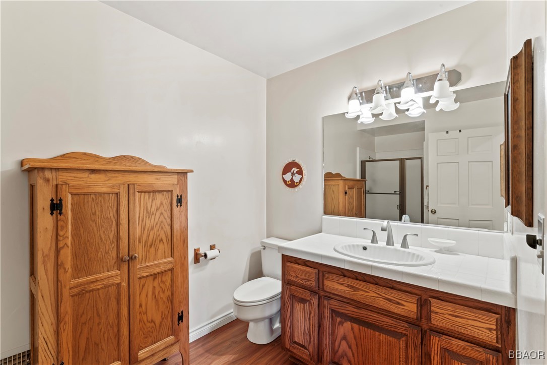 524 Golf Course Road Lake Arrowhead, CA 92352 - Photo 43 of 50 a bathroom with a sink a toilet and mirror