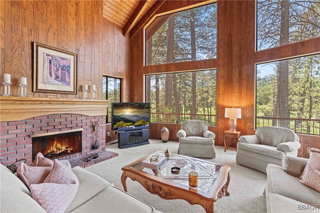 524 Golf Course Road Lake Arrowhead, CA 92352 - Photo 5 of 50 a living room with furniture a fireplace and large windows