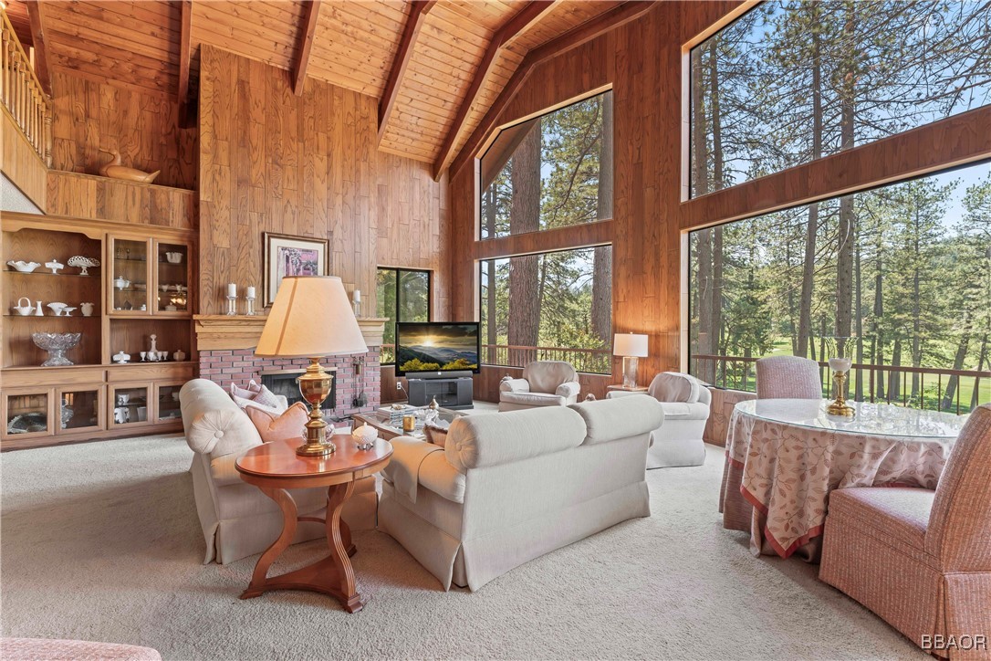 524 Golf Course Road Lake Arrowhead, CA 92352 - Photo 6 of 50 a living room with furniture a large window and a flat tv screen