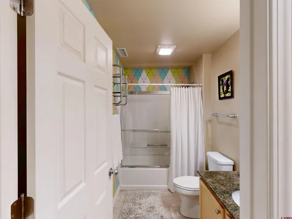 a bathroom with a toilet and a shower