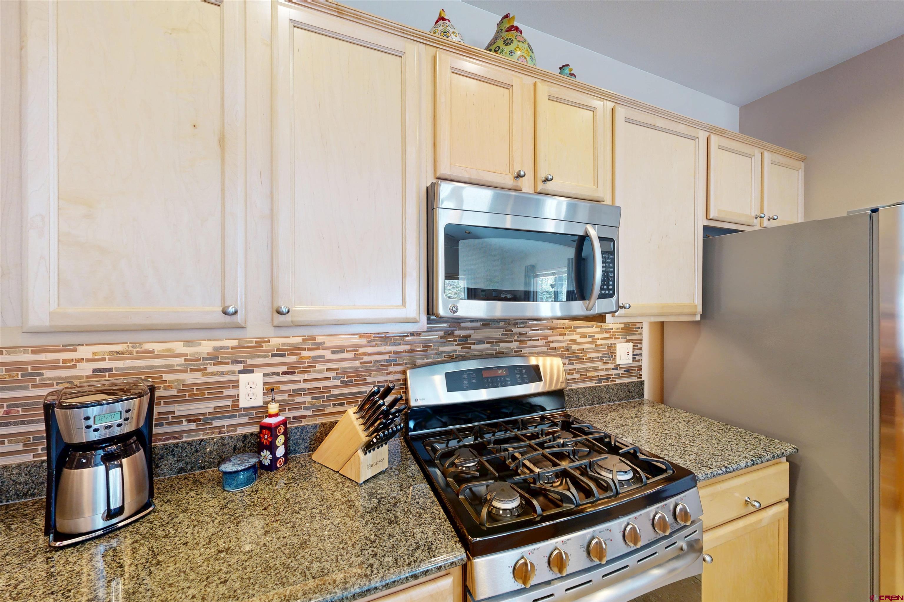 841 Woodbridge Way Durango, CO 81301 - Photo 24 of 27 a kitchen with a stove and a microwave