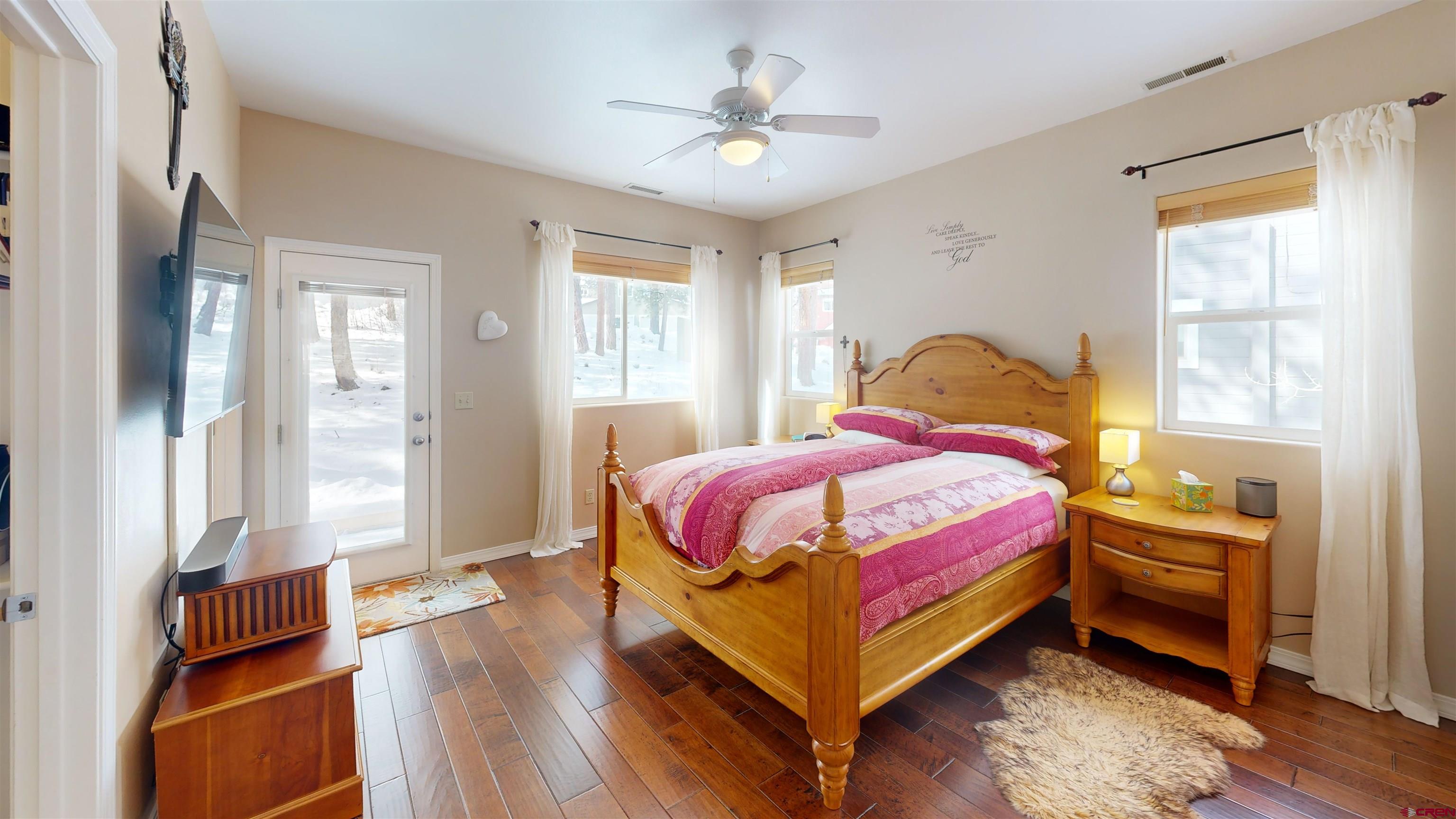 841 Woodbridge Way Durango, CO 81301 - Photo 25 of 27 a bedroom with a bed and a chandelier