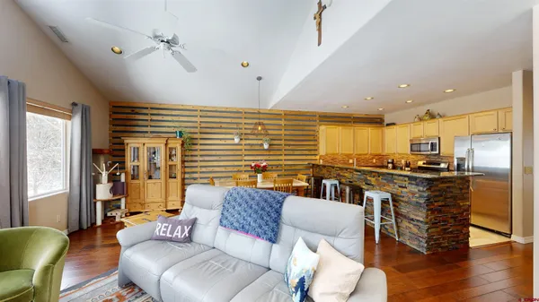 a living room with furniture and wooden floor