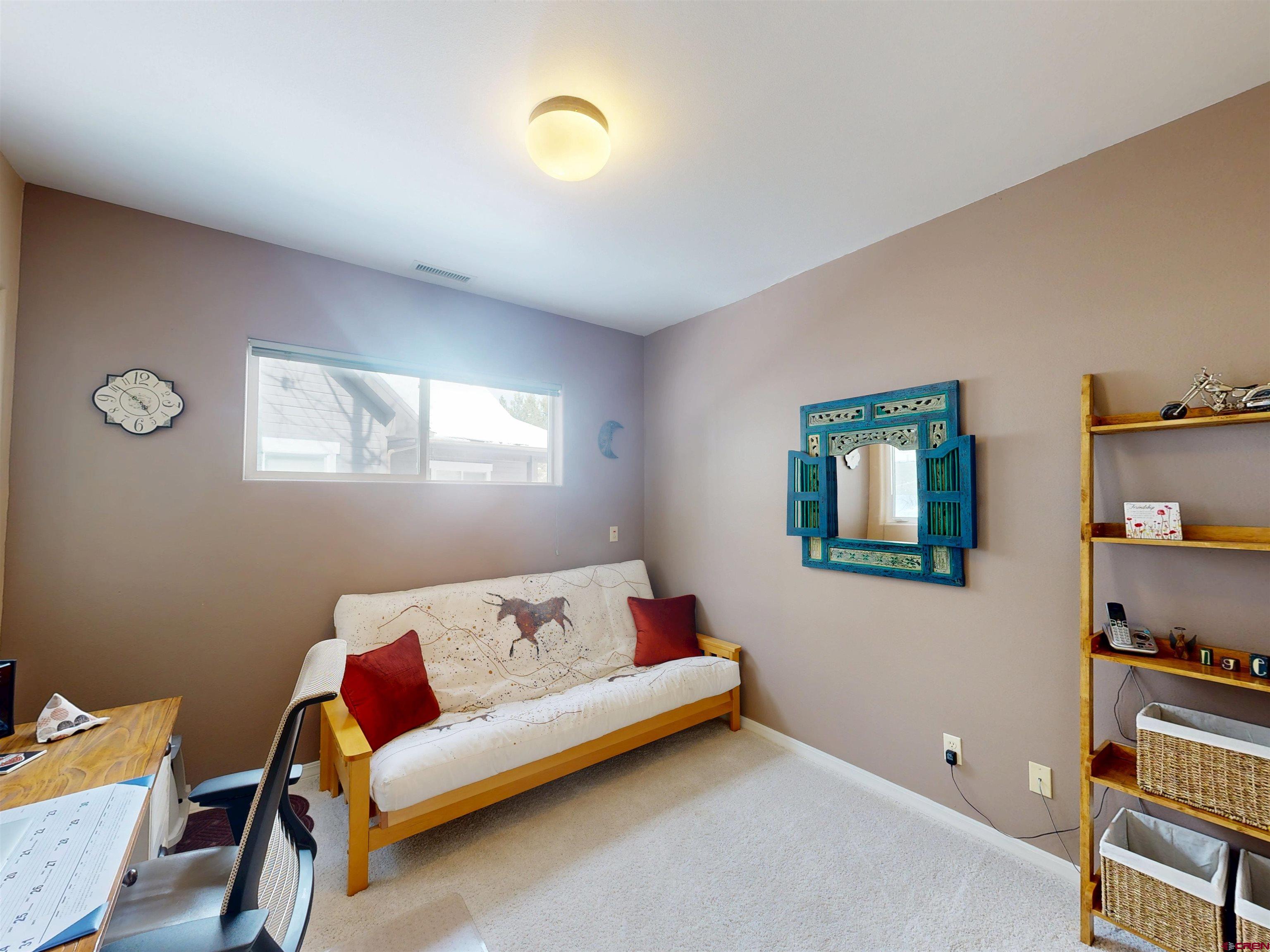 841 Woodbridge Way Durango, CO 81301 - Photo 10 of 27 a bedroom with furniture and a window