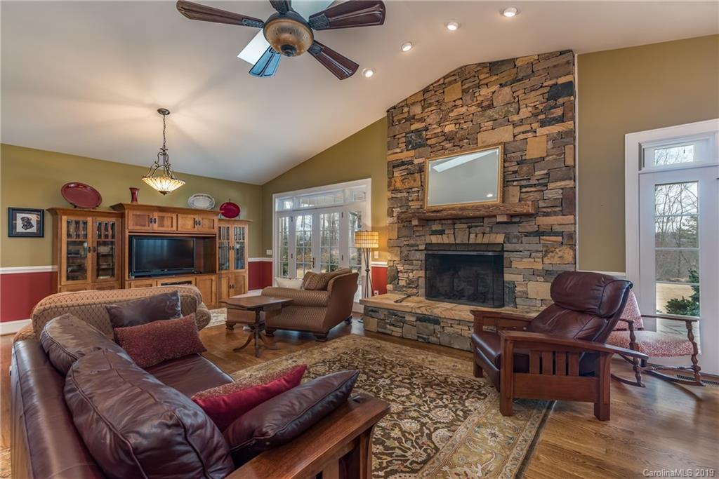 1723 Clark Road Rutherfordton, NC 28139 - Photo 11 of 37 a living room with furniture a fireplace and a chandelier