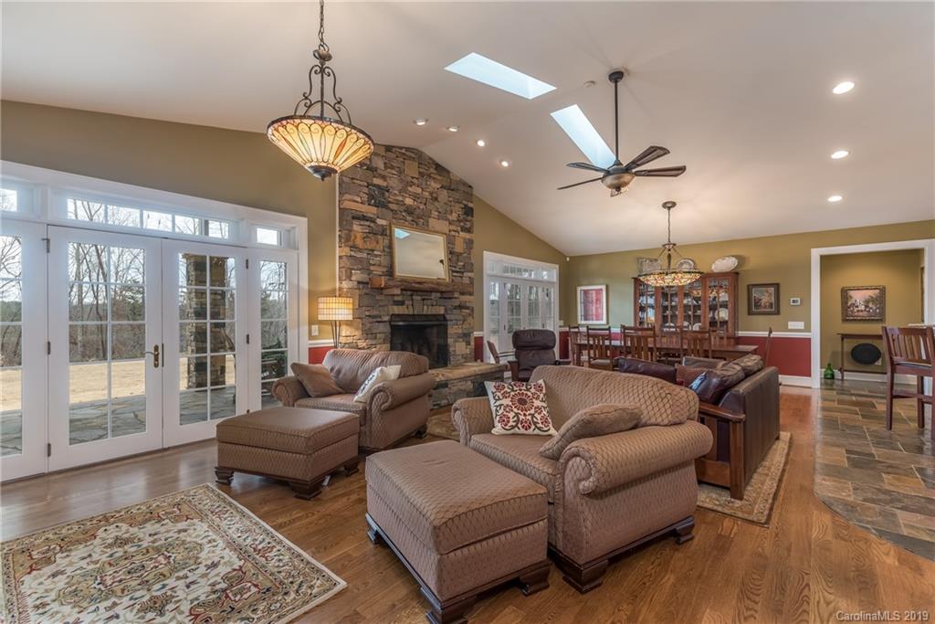 1723 Clark Road Rutherfordton, NC 28139 - Photo 13 of 37 a living room with furniture a fireplace and a chandelier