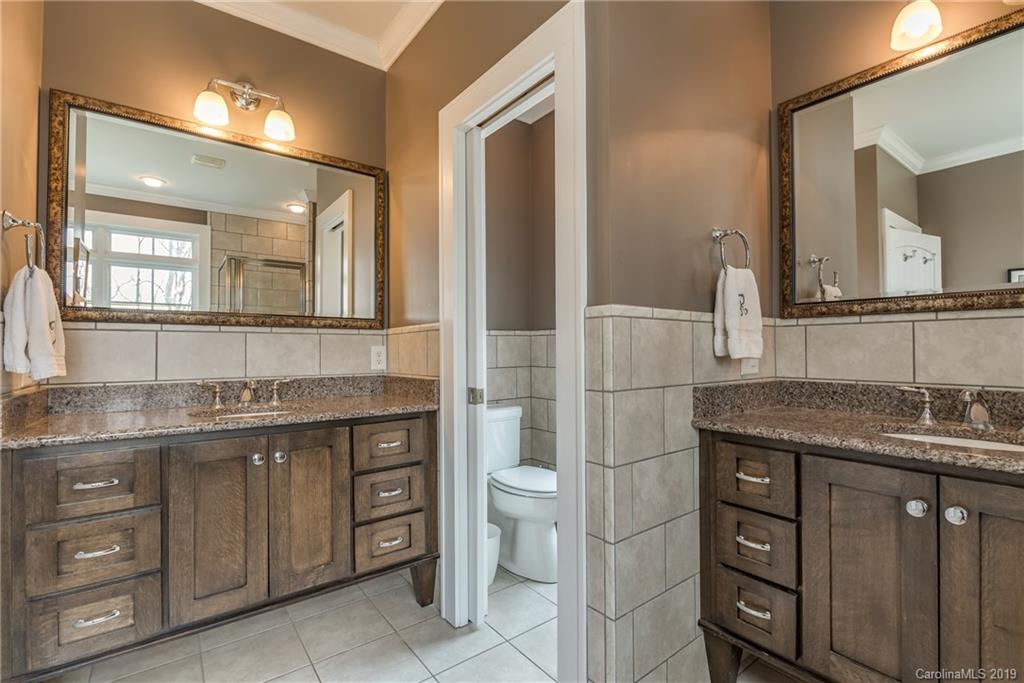 1723 Clark Road Rutherfordton, NC 28139 - Photo 18 of 37 a bathroom with a granite countertop toilet sink and mirror