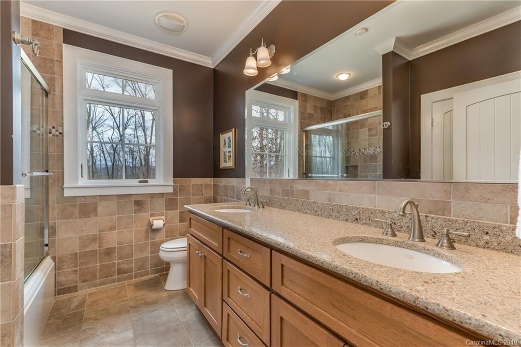 1723 Clark Road Rutherfordton, NC 28139 - Photo 20 of 37 a bathroom with a granite countertop sink mirror and a bathtub
