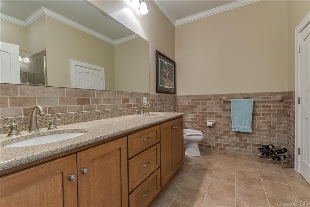 1723 Clark Road Rutherfordton, NC 28139 - Photo 26 of 37 a bathroom with a granite countertop sink a toilet and a mirror