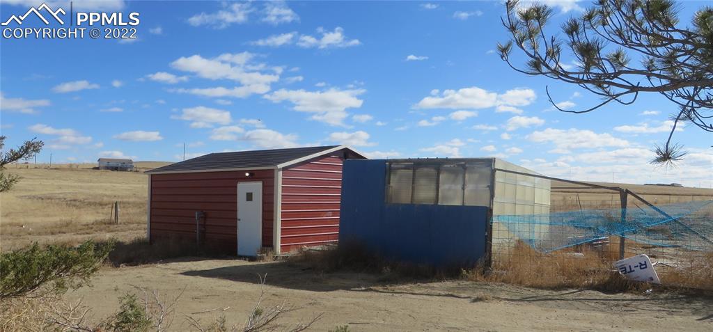 33895 Bellemont Road Yoder, CO 80864 - Photo 8 of 10 a view of a house with a backyard