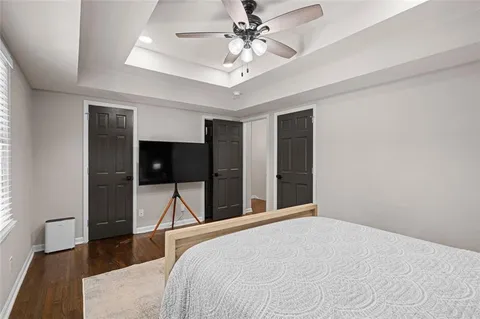 a bedroom with a bed and a chandelier