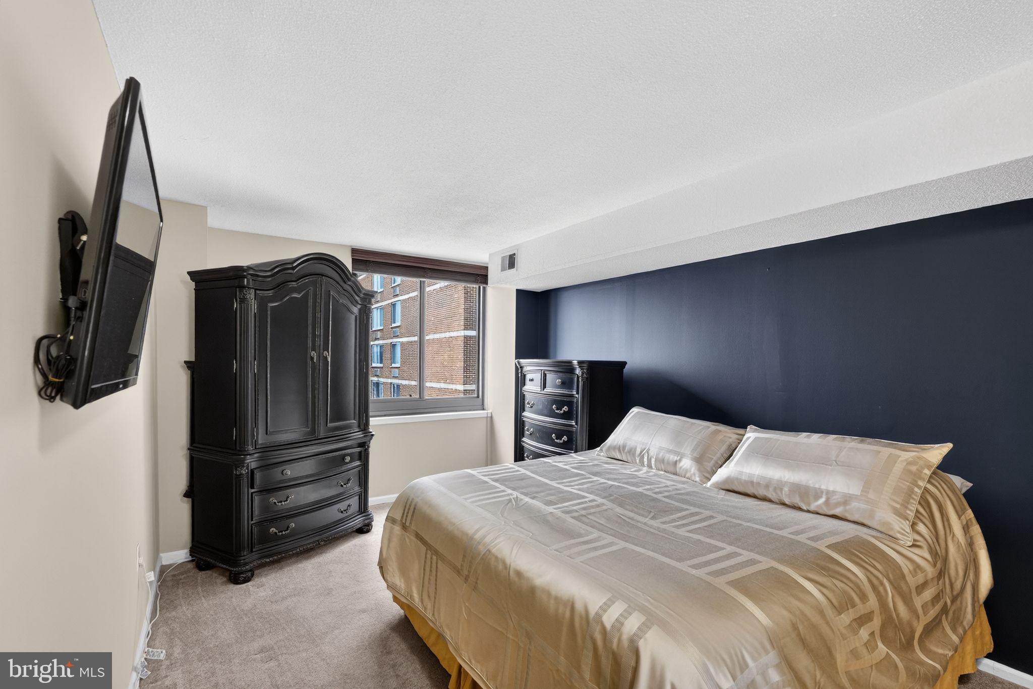 1420 Locust Street, Unit 31I Philadelphia, PA 19102 - Photo 15 of 25 a bedroom with a bed and a television