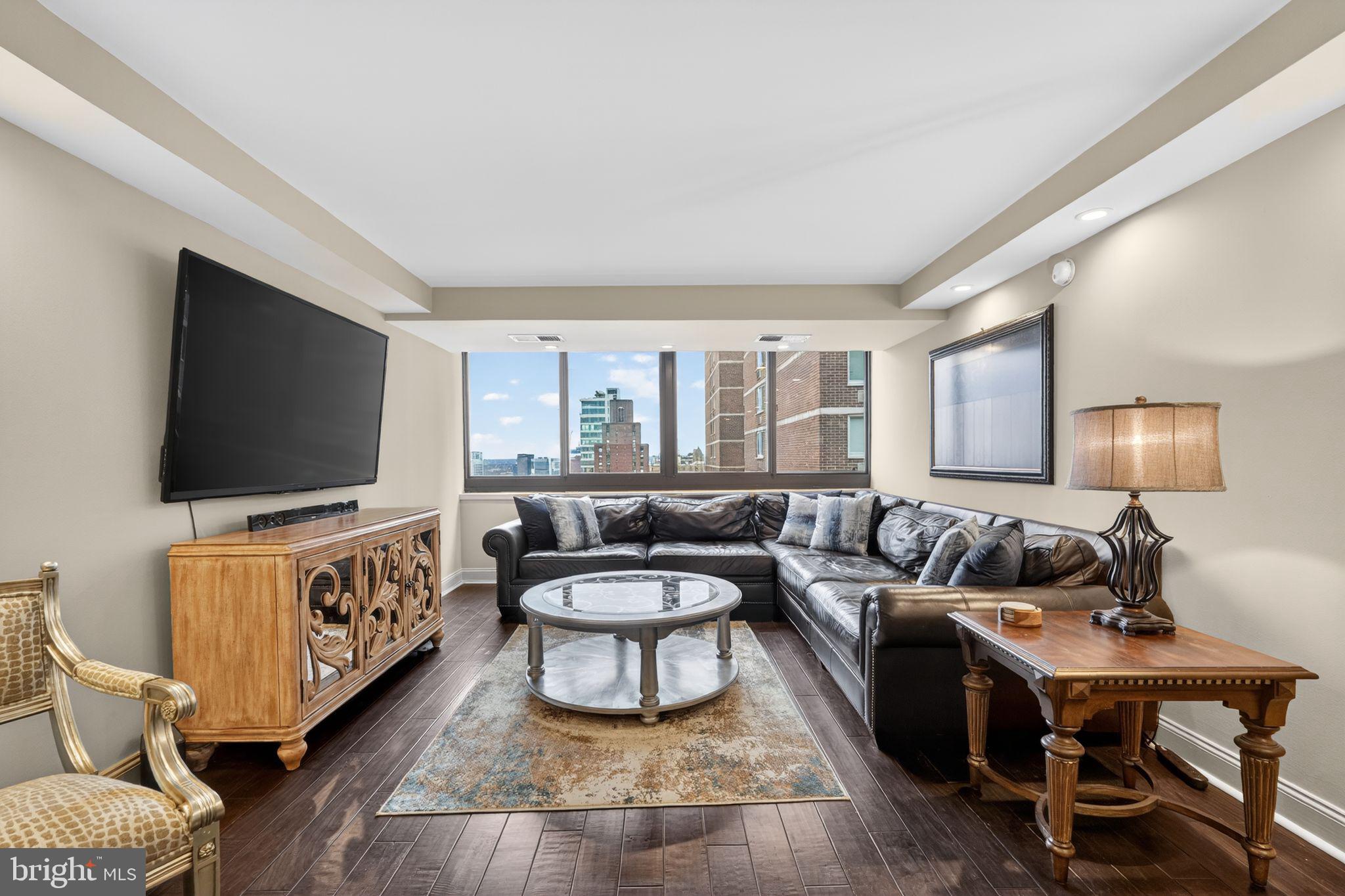 1420 Locust Street, Unit 31I Philadelphia, PA 19102 - Photo 5 of 25 a living room with furniture and a flat screen tv