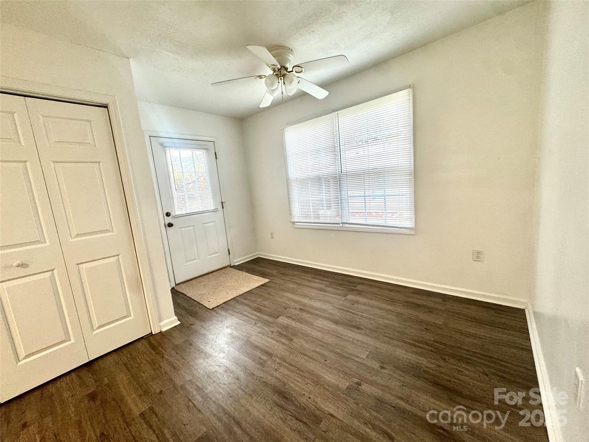 117 24th Street Northwest Hickory, NC 28601 - Photo 11 of 22 a view of an empty room with wooden floor and a window