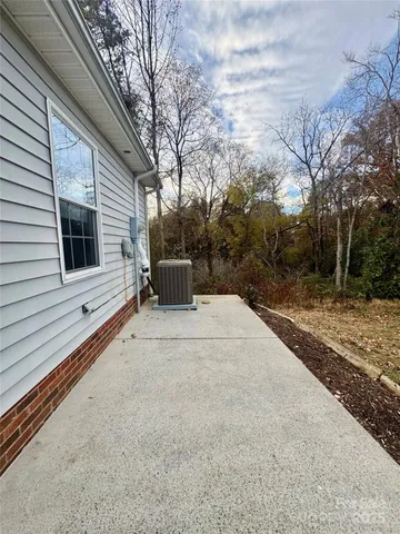 a backyard of a house with table and sofas