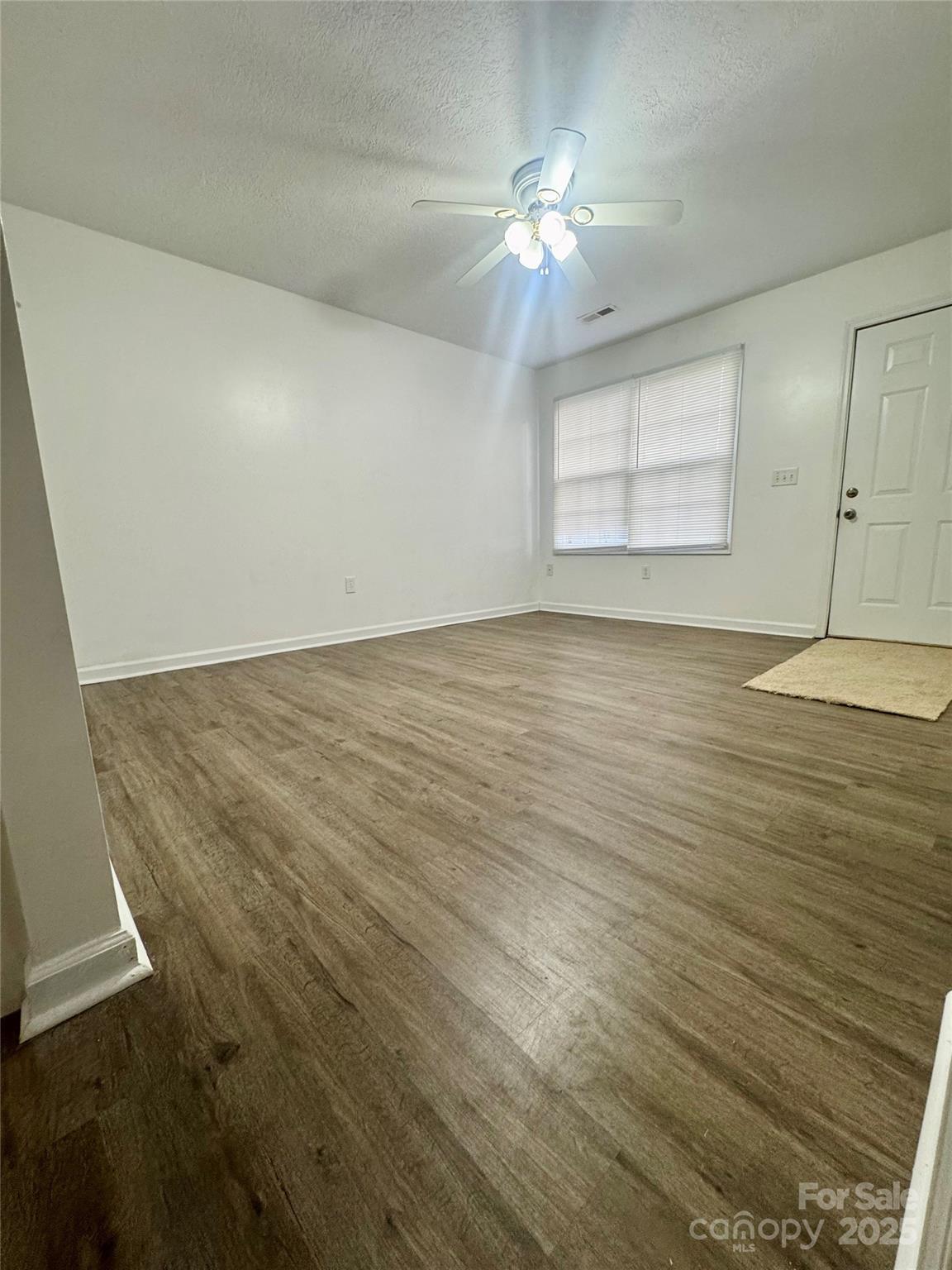 117 24th Street Northwest Hickory, NC 28601 - Photo 5 of 22 a view of an empty room with chandelier fan and wooden floor