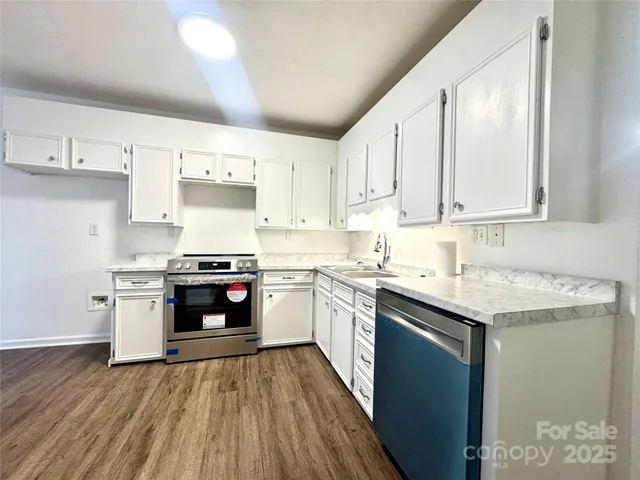 a kitchen with stainless steel appliances granite countertop a stove and a sink