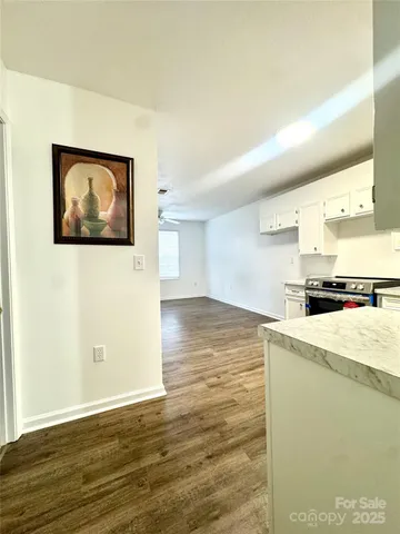 a view of a kitchen with wooden floor and a sink