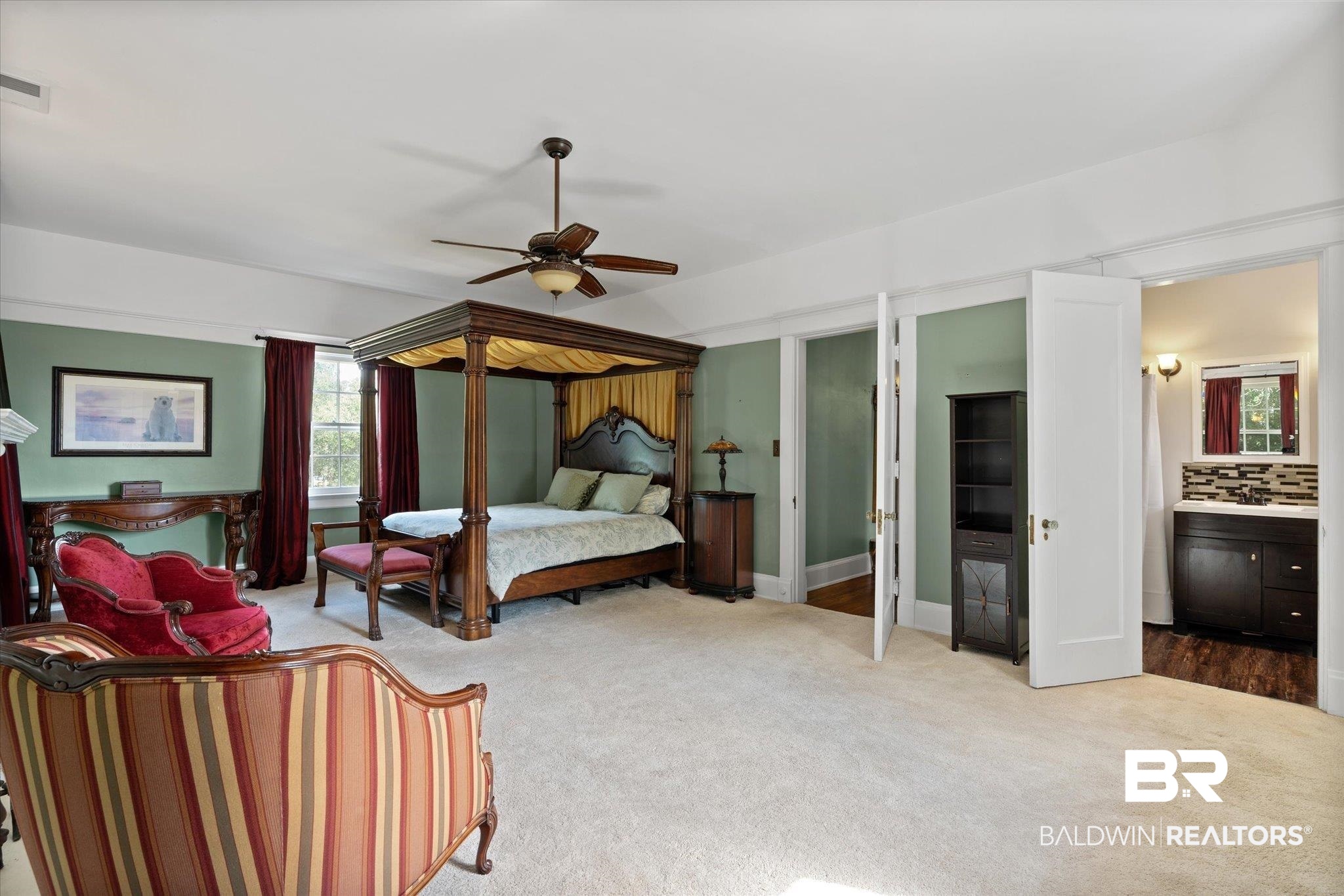 1953 Dauphin Street Mobile, AL 36606 - Photo 20 of 56 Bedroom with light carpet, ceiling fan, and ensuite bathroom
