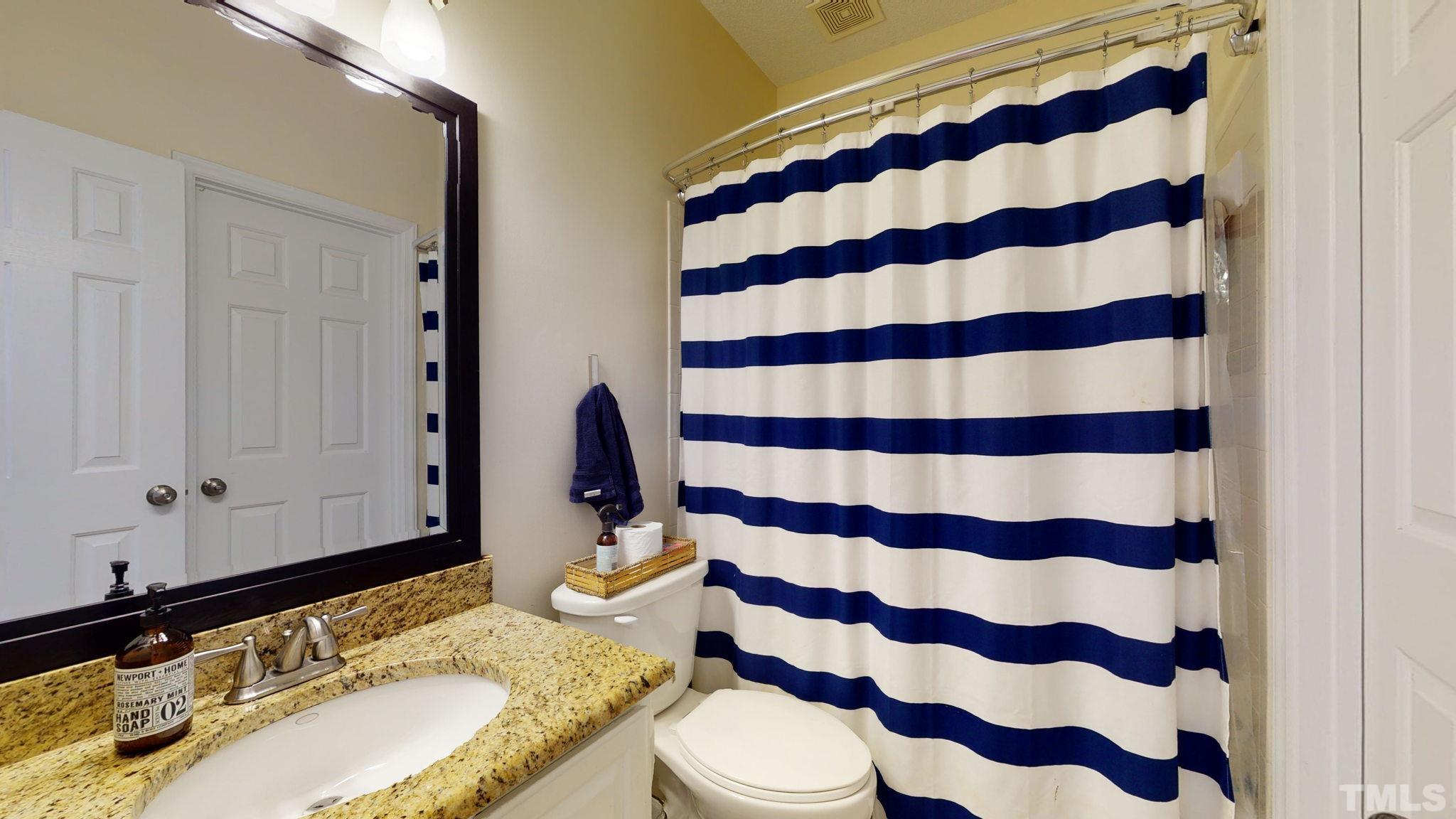 7900 Broad Street Raleigh, NC 27613 - Photo 19 of 53 a bathroom with a granite countertop sink and a mirror