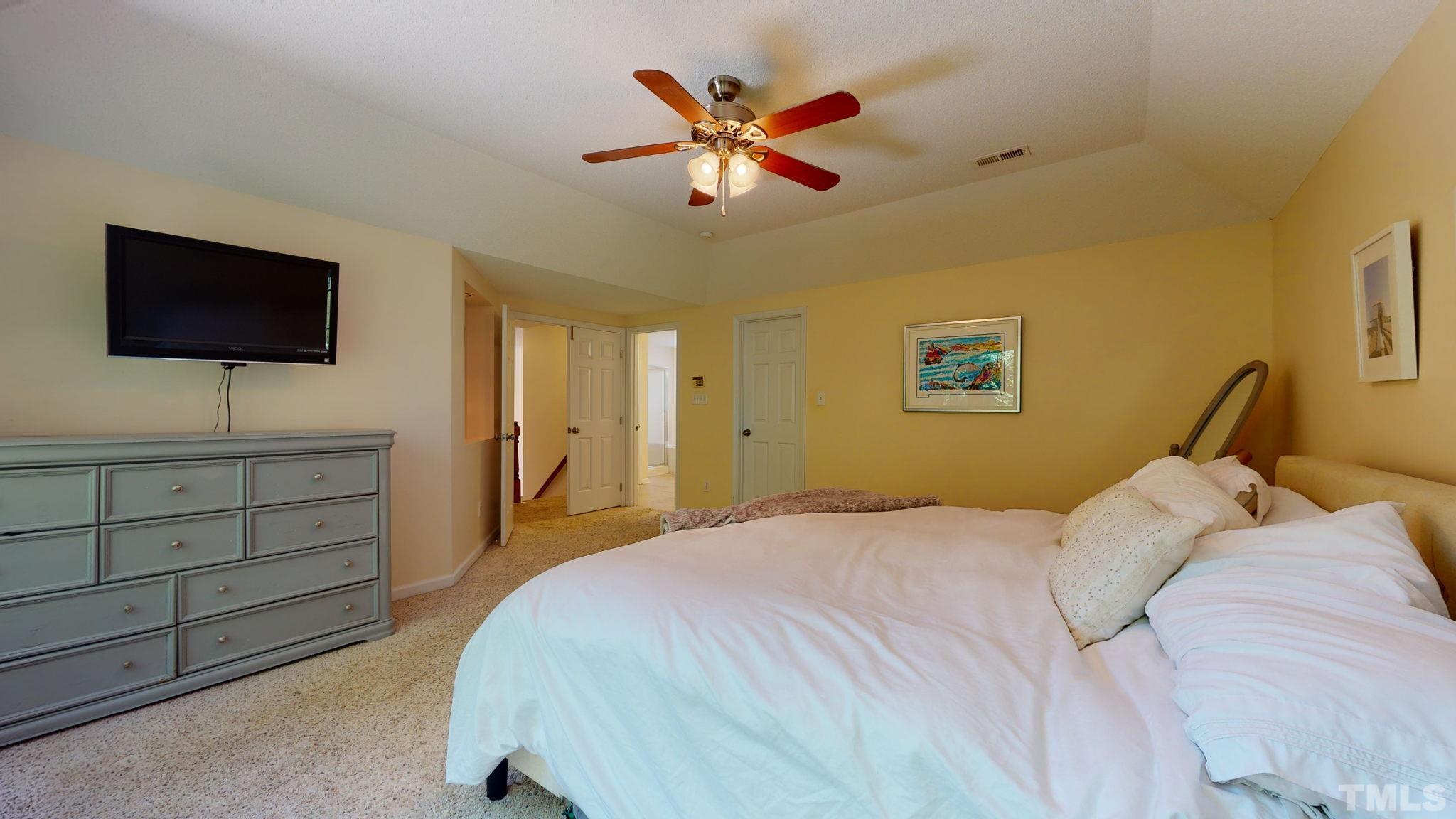 7900 Broad Street Raleigh, NC 27613 - Photo 30 of 53 a bedroom with a bed and a flat screen tv