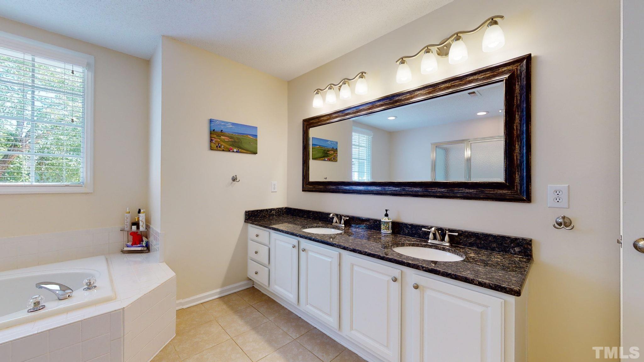 7900 Broad Street Raleigh, NC 27613 - Photo 33 of 53 a bathroom with a double vanity sink and a mirror