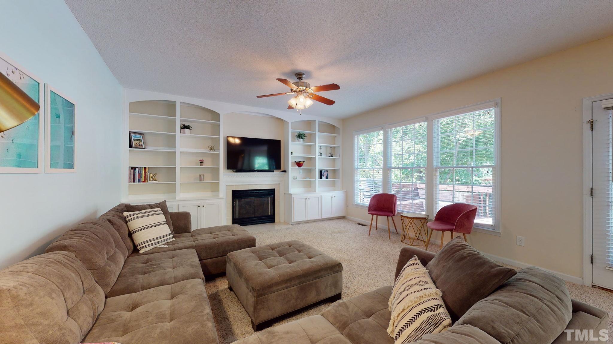 7900 Broad Street Raleigh, NC 27613 - Photo 5 of 53 a living room with furniture fireplace and flat screen tv