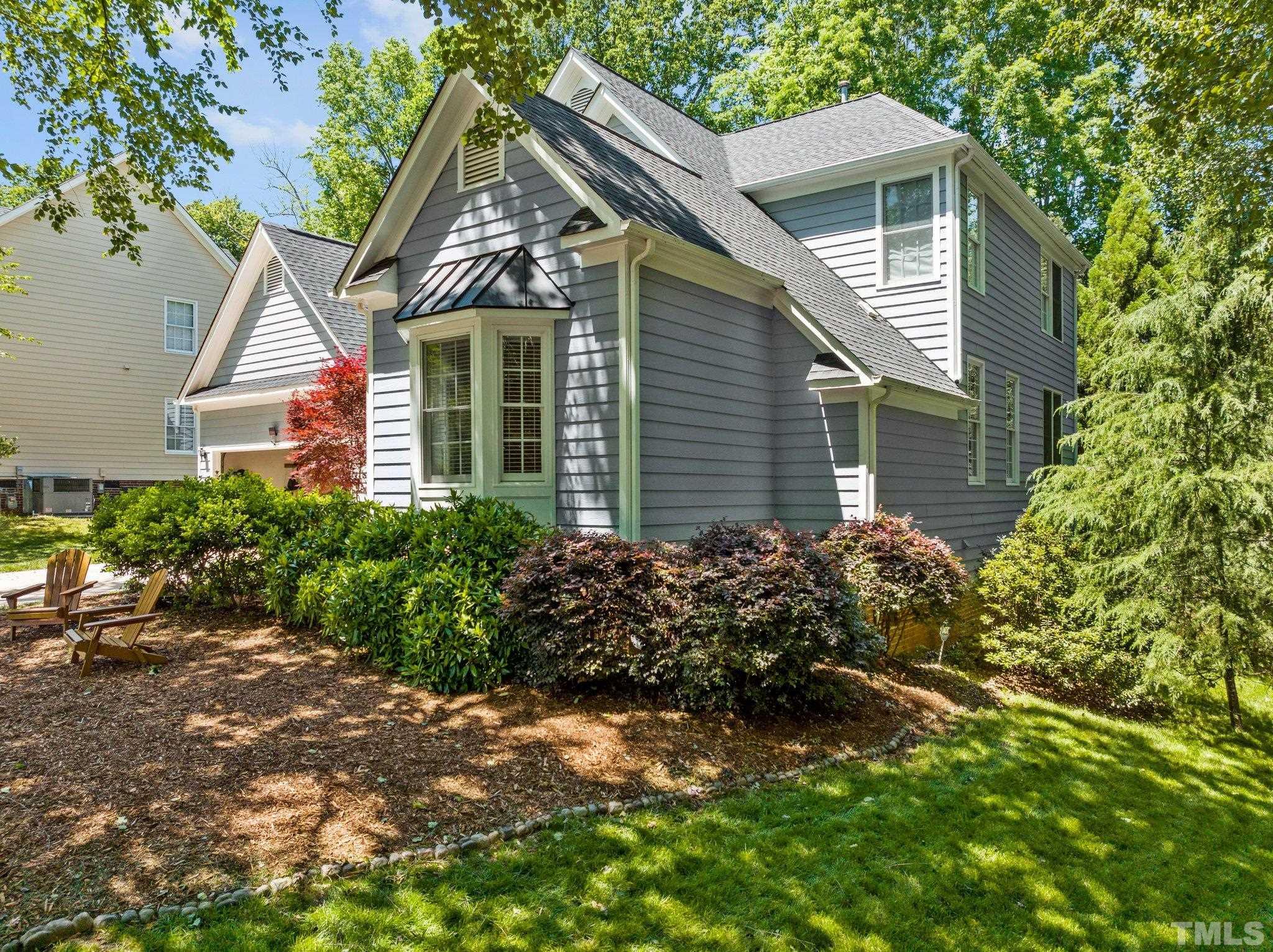 7900 Broad Street Raleigh, NC 27613 - Photo 51 of 53 a view of a house with a small yard plants and a large tree