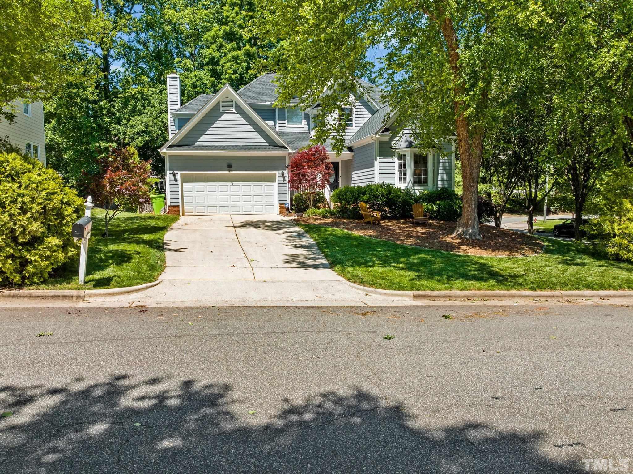 7900 Broad Street Raleigh, NC 27613 - Photo 53 of 53 a front view of a house with a yard and a garage