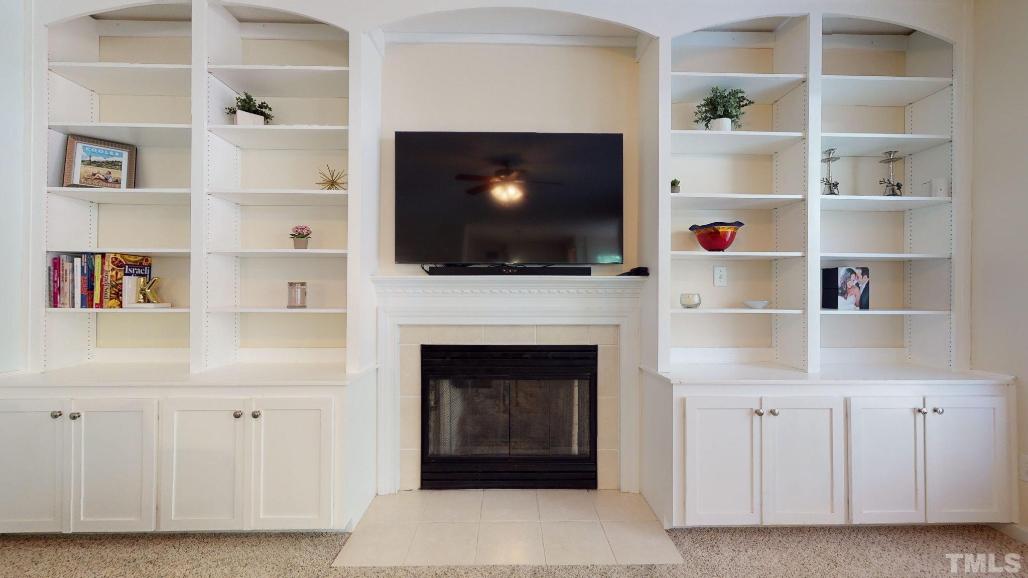 7900 Broad Street Raleigh, NC 27613 - Photo 6 of 53 a living room with a fireplace and a flat screen tv