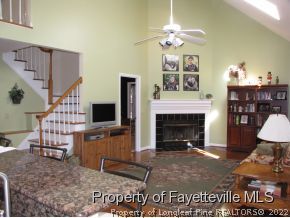 165 Cliff Road Southern Pines, NC 28387 - Photo 2 of 11 a living room with furniture a fireplace and a flat screen tv