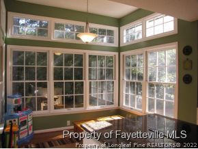 165 Cliff Road Southern Pines, NC 28387 - Photo 4 of 11 a view of an empty room with wooden floor and a window