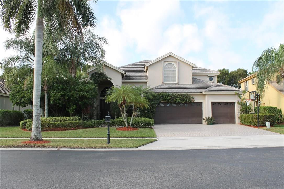 21491 Halstead Drive Boca Raton, FL 33428 - Photo 1 of 35 a view of a house with a small yard plants and palm trees