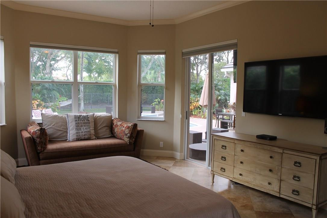 21491 Halstead Drive Boca Raton, FL 33428 - Photo 14 of 35 a bedroom with furniture and a flat screen tv