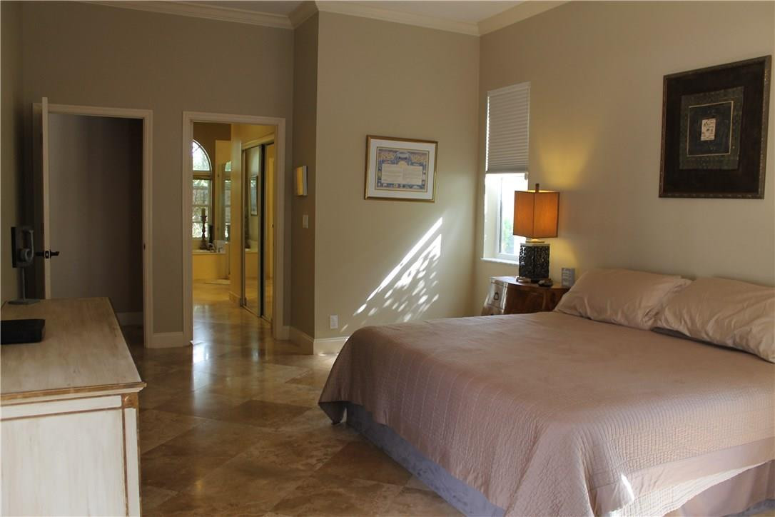 21491 Halstead Drive Boca Raton, FL 33428 - Photo 15 of 35 a bedroom with a bed and a refrigerator