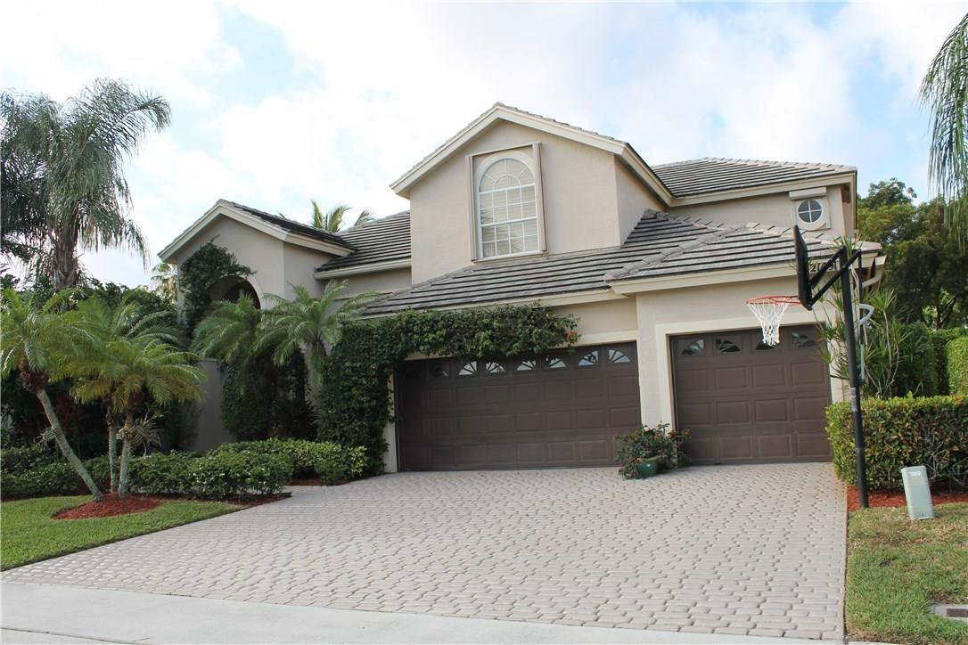 21491 Halstead Drive Boca Raton, FL 33428 - Photo 3 of 35 a front view of a house with a garden and plants
