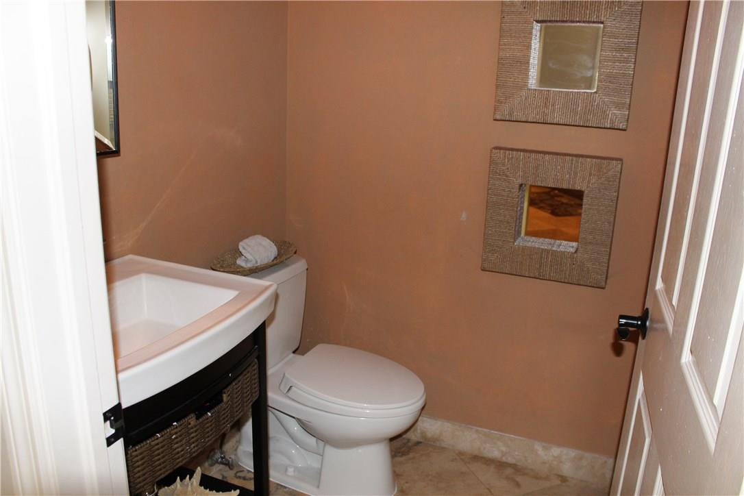 21491 Halstead Drive Boca Raton, FL 33428 - Photo 33 of 35 a bathroom with a sink a toilet and a mirror